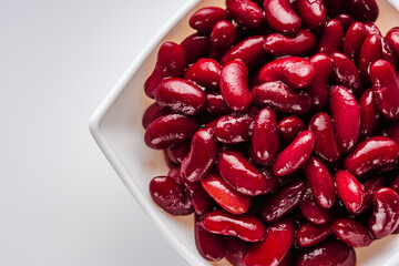 canned red kidney beans on a white acrylic background