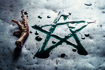 Pentagram painted with green paint on a metal table