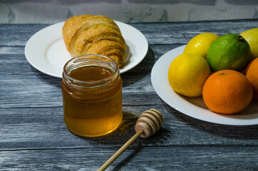 Still life with fresh fruits and glass of juice on the wooden background
