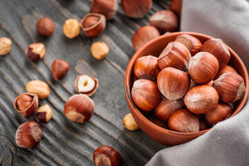 fresh natural hazelnuts on a dark wooden rustic background