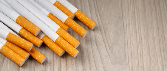 cigarettes. pile on wooden background. image of several commercially made or Non smoking campaign concept, tobacco.