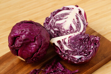 cabbage and cutted sliced on wooden cutting board. Purple vegetables.