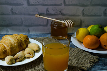 Still life with fresh fruits and glass of juice on the wooden background