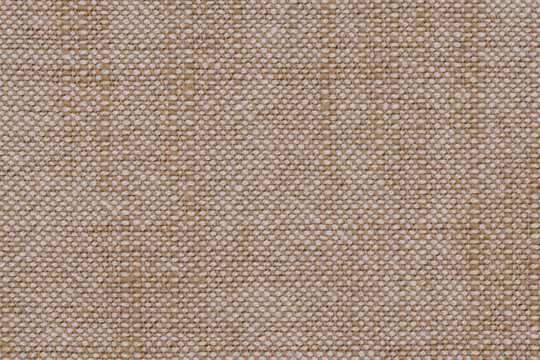 A weave pattern of white-beige fibres fabric. Textile texture as a background