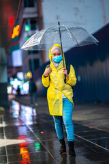 Young teenager walking during raining season with available light.