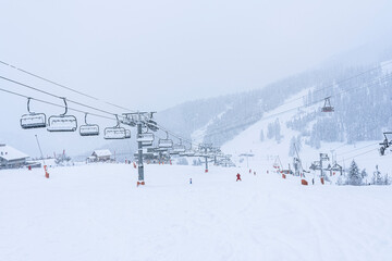 Auron, FRANCE - 01.01.2021: Empty ski slopes and ski lifts in ski resort. During the winter holidays 2021 January lifts are closed for skiing for adults due to the coronavirus pandemic.