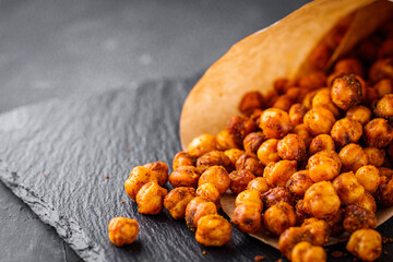 fried chickpeas on a dark stone background