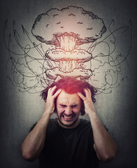 Head explosion metaphor. Bewildered man messing up and pulling his hair,  eyes closed screaming and...