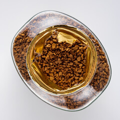 instant coffee granules on a white acrylic background