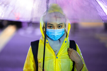 Young teenager walking during raining season with available light.