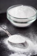 baking soda powder on a dark stone background