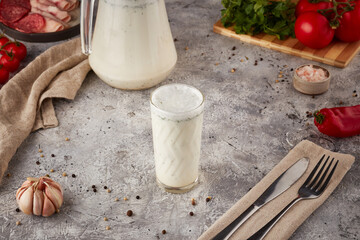 Sour milk drink with herbs, textured background