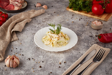 Vegetable salad with cream sauce, textured background