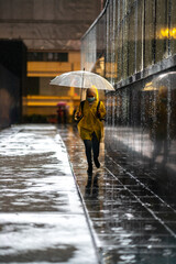 Young teenager walking during raining season with available light.