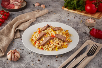 Rice with stew, vegetables and spices, Uzbek cuisine, textured background