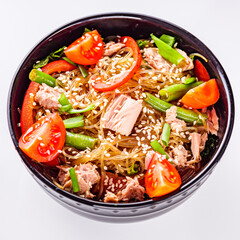 delicious glass noodles with tuna and vegetables on a white acrylic background