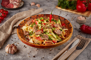 Rice with stew, vegetables and spices, Uzbek cuisine, textured background