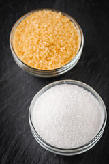 cane brown sugar on a dark stone background