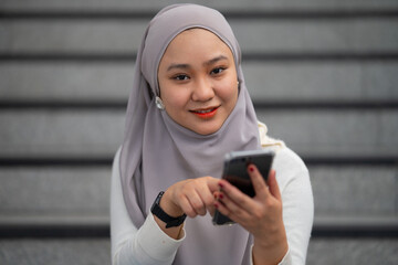 Young teenager hold the telephone at staircase. Communication concept.