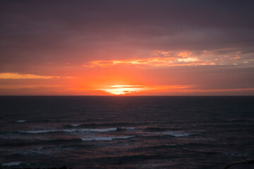 Naklejka na ściany i meble Dramatic sunset on the sea