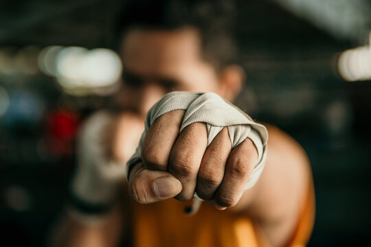 Close Up Of Hand Boxer In Wrapping Bandage Make A Jab Motion In The Ring