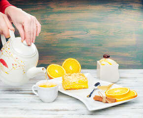 Hot tea with a mug spoon oops orange slices and sugar. Cozy home tea concept