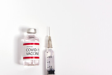 Coronavirus vaccine, syringe and needle on white background.