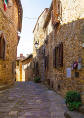 Fototapeta na wymiar A quiet street of residential buildings in the historic medieval village of Montefioralle near Greve in Chianti in Florence province, Tuscany, Italy 