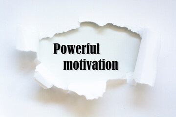 Powerful motivation word written under torn paper concept.