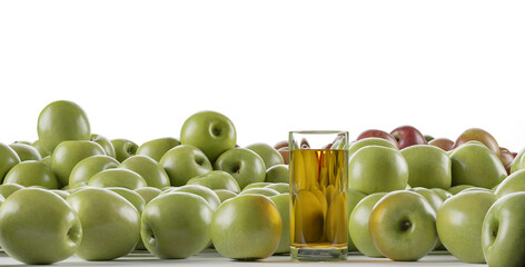 a glass of apple juice and lots of green apples