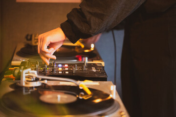 close up of dj hands working on his turntables 