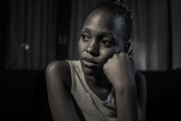 teen African American girl at night suffering depression - dramatic artistic portrait of young...