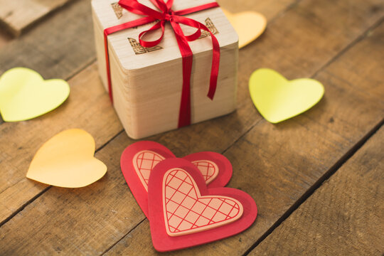 Image of Valentine's day, symbols of love, gift box on a background of wooden planks. 2
