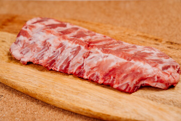 raw pork ribs on a wooden cutting board. Buying meat to cook at home. butcher shop.