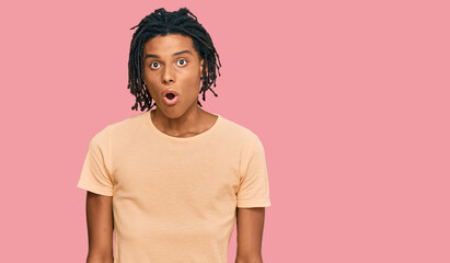Young african american man wearing casual clothes afraid and shocked with surprise expression, fear and excited face.