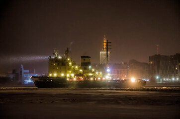 Fototapeta na wymiar January 2021- Arkhangelsk. The Dikson icebreaker against the background of the city of Arkhangelsk. Russia, Arkhangelsk region 