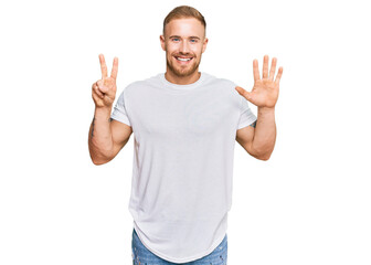 Naklejka premium Young irish man wearing casual clothes showing and pointing up with fingers number seven while smiling confident and happy.