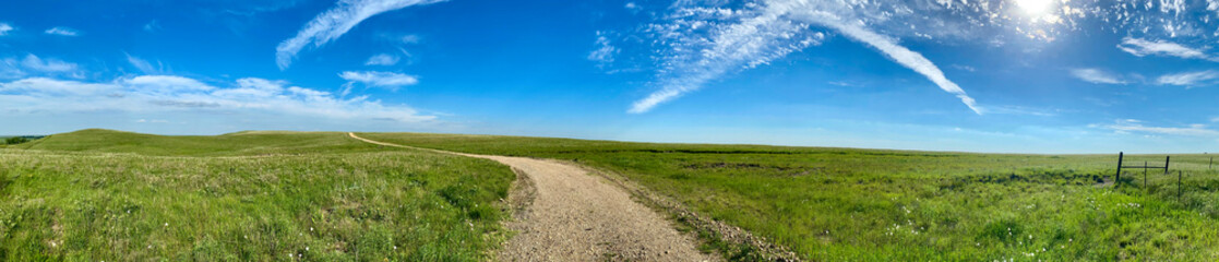 panorama panoramic of green pasture countryside with blue sky and white clouds 