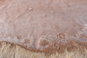 Pink water top aerial view from algae, salt, and minerals in Ras al Khaimah, United Arab Emirates.