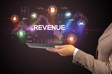 Close-up of a touchscreen with REVENUE inscription, business opportunity concept