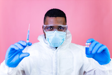 Corona Virus SARS-CoV-2 vaccination concept : man in pink studio wall background