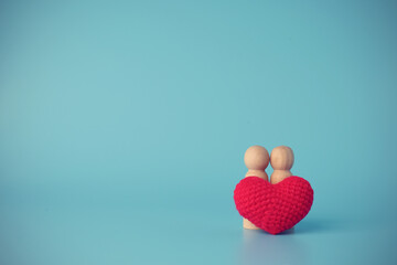 Red hearts put front Couples doll wood with on blue background with a copy space. Concept love, Valentine festival new normal.