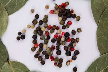 bay leaf with peppercorns on a white background