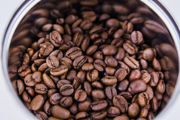 roasted coffee beans in a round jar