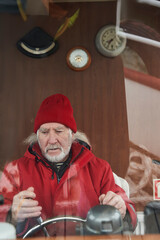 Captain holding the wheel on the deck of the ship