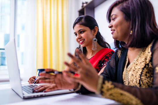 Two Beautiful Women In Tradition Sari Working At Office Or Cafe