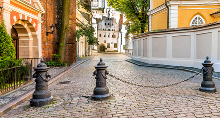 Square with column and chain near an entrance to medieval church in old Riga - the capital of Latvia