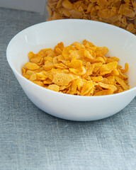 Bowl of cornflake in white container ,Signifying healthy breakfast