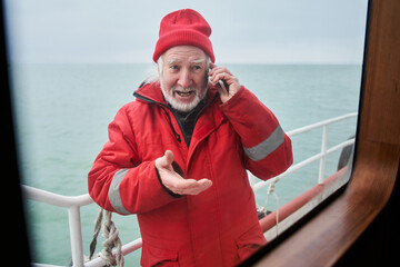 Man using smartphone while connecting with colleagues