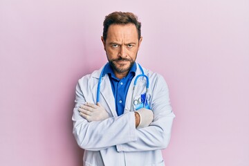 Middle age man wearing doctor uniform and stethoscope skeptic and nervous, disapproving expression...